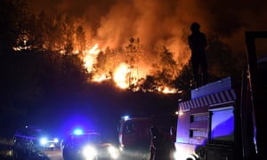 Firefighters try to extinguish a forest wildfire in Colmeal in central Portugal on 21 June