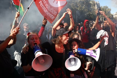 Protesters use megaphones and wave flags