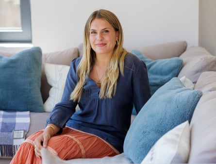 Student Erin on the sofa in her home