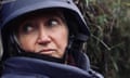 A closeup of Lindsey Hilsum wearing a military helmet and body armour.