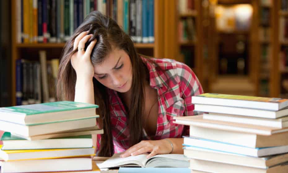 Focused student surrounded by books