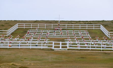 graves with floral tributes in a fenced enclosure