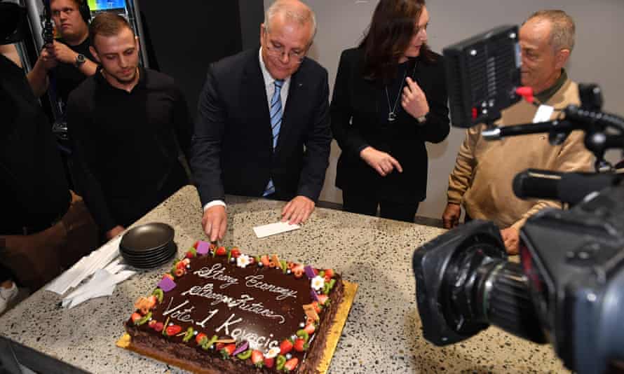Prime minister Scott Morrison and Liberal candidate for Parramatta Maria Kovacic with a cake that says “strong economy”