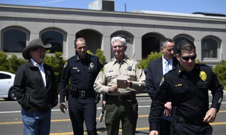 San Diego county sheriff Bill Gore, center, arrives with other law enforcement officials outside of the Chabad of Poway synagogue.