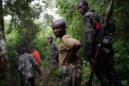 M23 rebels walk through the jungle next to the Rwindi river, near the village of Mabenga in North Kivu province.
