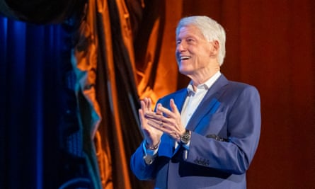 Bill Clinton applauds at Radio City Music Hall.