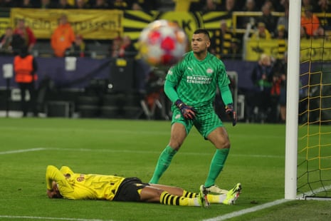Dortmund's Donyell Malen (left) reacts next to PSV Eindhoven goalkeeper Walter Benitez during their Champions League last 16 second leg match.