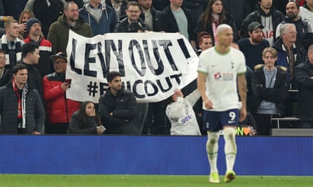 Supporters hold up a banner protesting about Daniel Levy