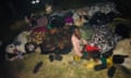 Refugees sleep on the floor, close together, under blankets while being held at Maula prison, Lilongwe, awaiting relocation to Dzaleka refugee camp.