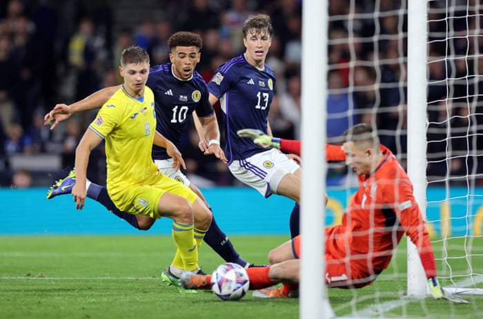 Scotland's Che Adams heads at goal but it's saved by Ukraine keeper Anatolii Trubin.