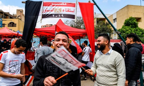 Egyptians wave flags stating ‘Do the right thing’ as part of the campaign to get voters to back the changes.