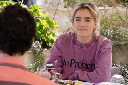 Portia in a purple “No Problemo” sweatshirt from the brand Aries