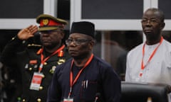 Abdel-Fatau Musah stands in front of an army officer who is saluting