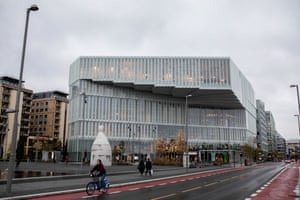 Pedestrians and a cyclist pass the new Deichman Library, Oslo’s main public library, in Oslo, Norway