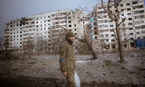 A Ukrainian soldier walks past destroyed buildings after attacks in the city of Orichiv, Zaporizhzhia.