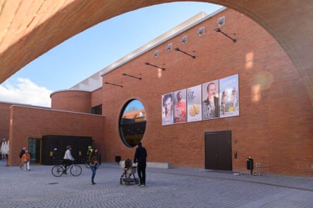 Theatre building under arch with posters