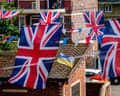 Union Jack flags fly from balconies at a brick housing estate in Bermondsey, South London, before a platinum jubilee party.