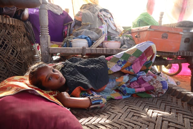 Aneesa, the daughter of Manzoor Ali, who is sick and laying on charpoi