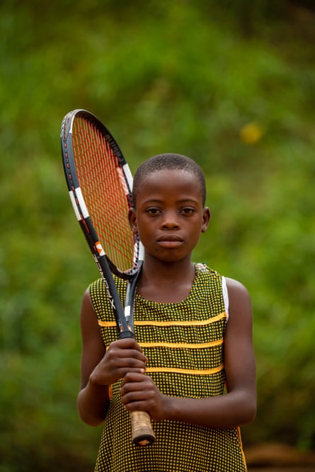 Patricia Nakawunde, 8, poses for a portrait before a training session during the Kampala Summer Tennis Camp at Makerere University Main Ground Courts on 31 July 2022. She’s one of the children that trek a long journey to attend training all the way from Kirolo, a village in Matuga 32 km from Kampala. Her passion for the sport and support from her parents helped her attend the three days of the Tennis Camp and regular Saturday training sessions held by the Tenna Academy.