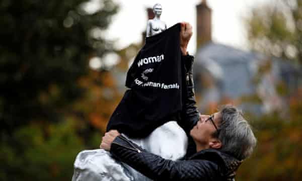 A protester covers the statue with a T-shirt.