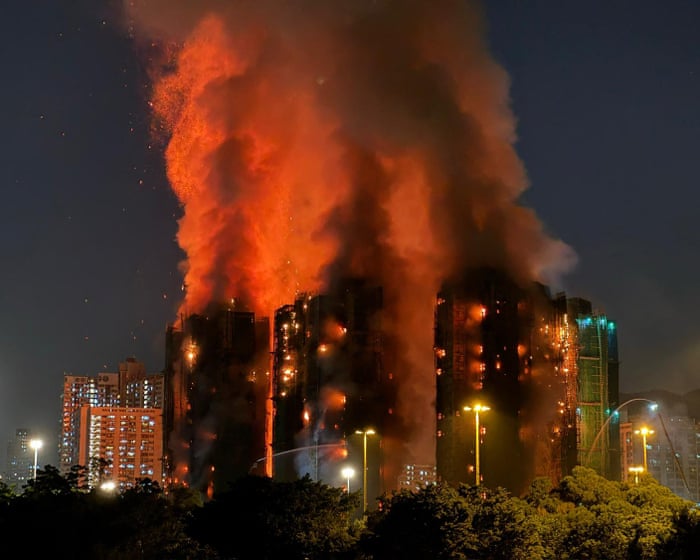 At least 13 dead after fire engulfs residential tower blocks in Hong Kong