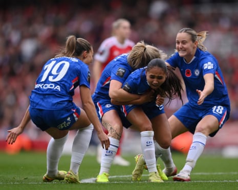 Alyssa Thompson of Chelsea celebrates with teammates after opening the scoring at Arsenal.