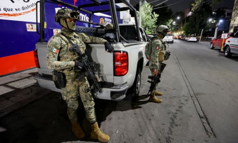 Troops guard the government office in Mexico City where former attorney general Jesús Murillo was held after his arrest