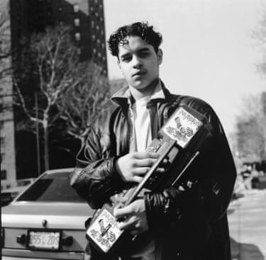 a young boy holding a boom box