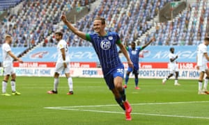 Wigan Athletic’s Kieran Dowell celebrates scoring his sides eighth goal while Hull’s players are disconsolate