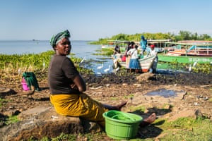 Women wait for fishermen to return with the catch, on the beach at Dunga village, near Kisumu, Kenya.