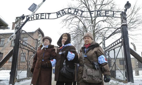 Auschwitz survivors stand outside the camp in January 2015, on the 70th anniversary of its liberation.
