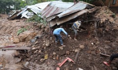 People dig for their belongings after their home was destroyed during a landslide following Cyclone Freddy in Blantyre, Malawi, earlier this month.