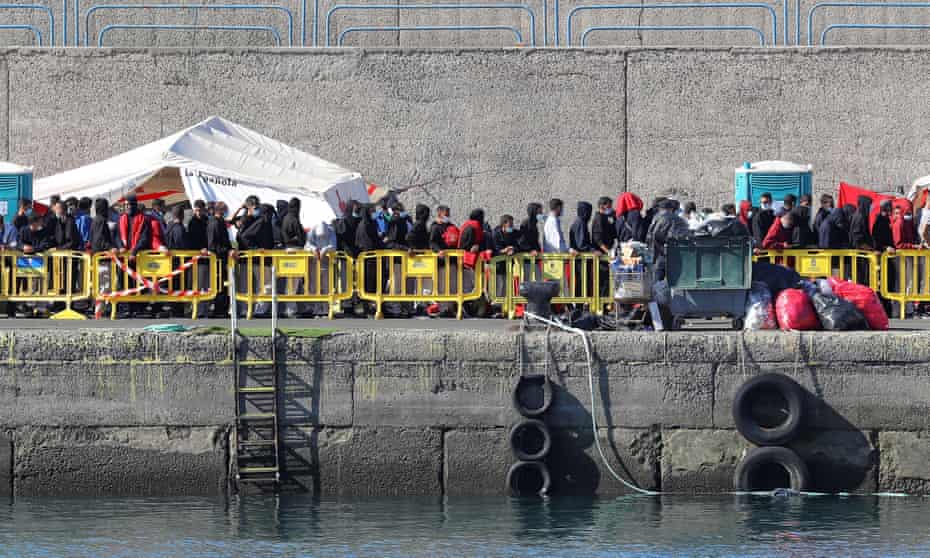Migrants queue up to receive assistance at Arguineguín port in Gran Canaria on Sunday. The regional president said almost 2,200 people were being housed on the docks.