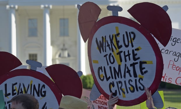 Climate protesters gather outside the White House.