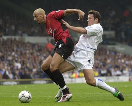 Rio Ferdinand holds off Leeds’ Mark Viduka