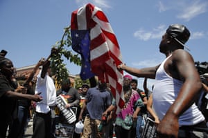 Counter-protesters burn an American flag.