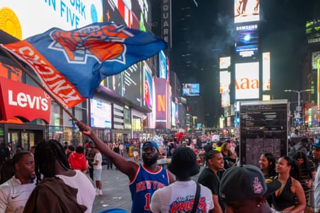 A Knicks fan waves a Knicks flag during celebration after the New York Knicks defeated the San Antonio Spurs in Game 5 of the NBA Finals to win the series