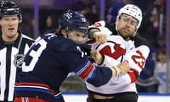 Kurtis MacDermid of the New Jersey Devils, right, fights with Matt Rempe of the New York Rangers during the first period at Madison Square Garden on on Wednesday.