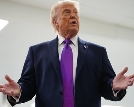 Trump speaks with his hands apart.