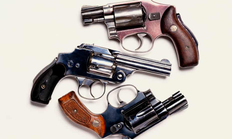 Three handguns, overhead view