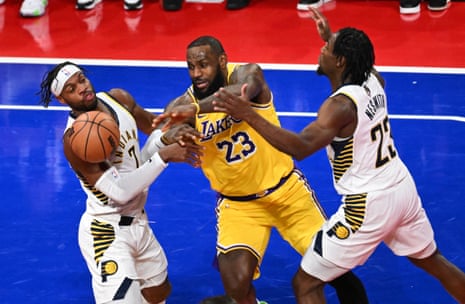 Los Angeles Lakers forward LeBron James (23) chases a loose ball against Indiana Pacers guard Buddy Hield (7) and forward Aaron Nesmith (23) during the second quarter.