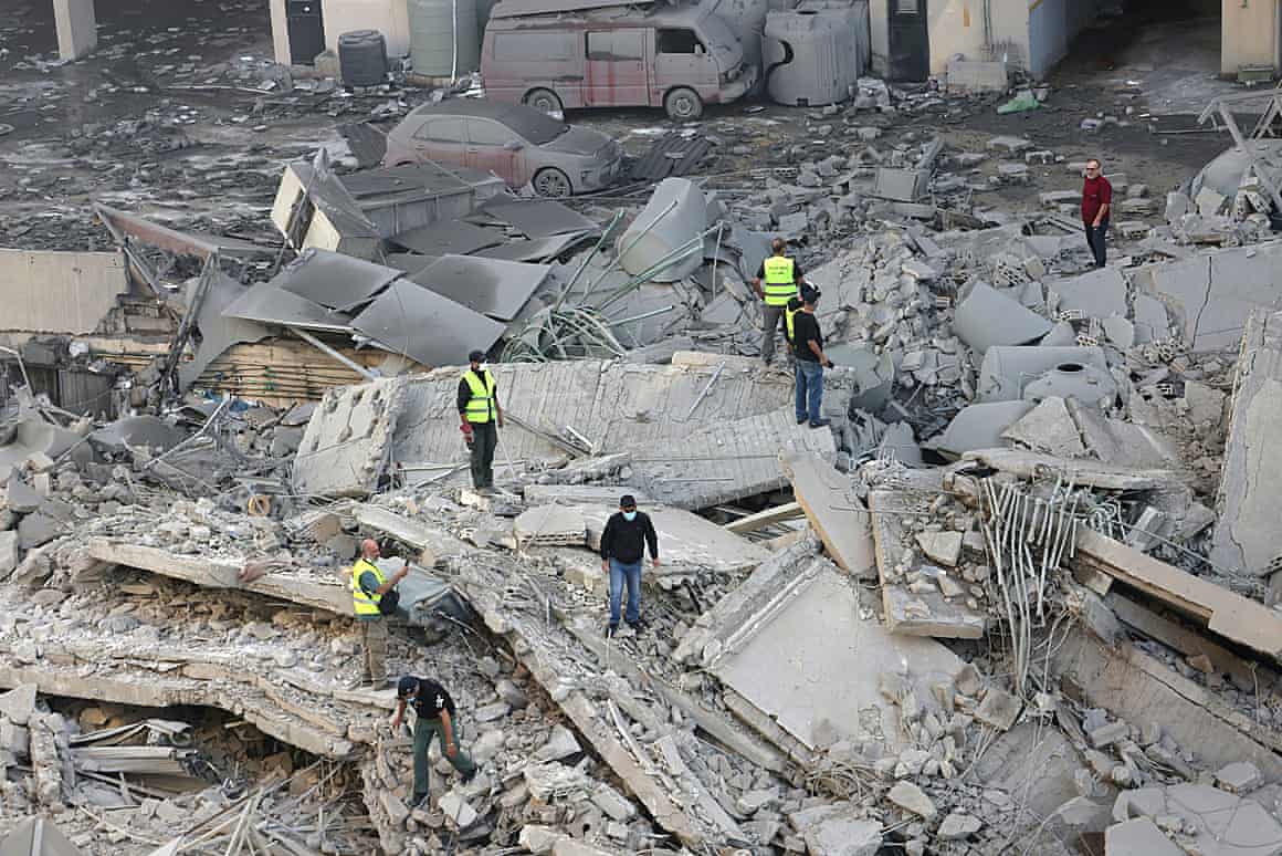 Rescuers check the site of an overnight Israeli airstrike in Beirut's southern suburb of Shayyah on 2 October