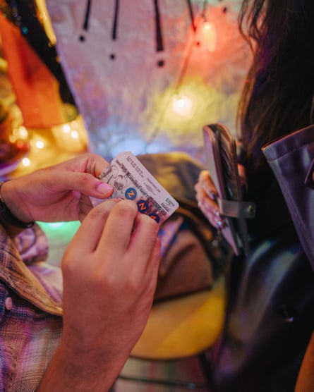 A canvasser receives a sticker for her “Zetro” card, counting the number of times she has canvassed.