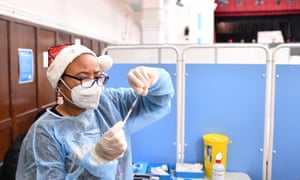 A NHS health worker prepares a dose of the Covid-19 vaccine at a pop-up coronavirus vaccination centre at the Redbridge Town Hall, east London on Christmas Day.