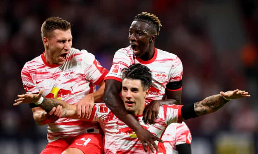 Dominik Szoboszlai (bottom) delights his Leipzig celebrates by scoring a superb opening goal.