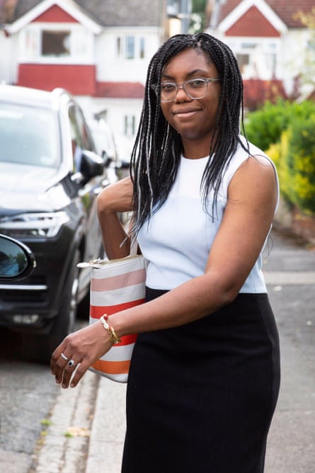 Kemi Badenoch on a street, smiling at the camera