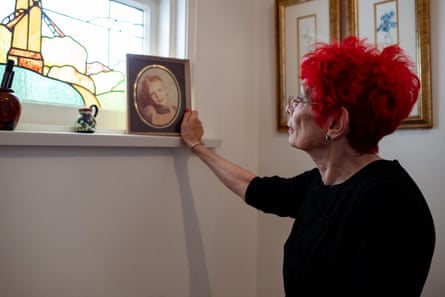 Judy Deacon looks at a framed photo of Jesse as a young boy