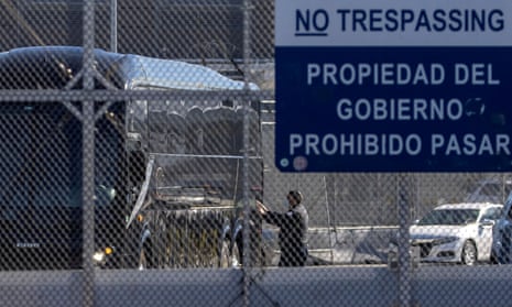 A bus leaves a closed border facility as migrants subject to a Trump-era asylum restriction program were expected to begin entry into the United States at the San Ysidro border crossing in San Diego.