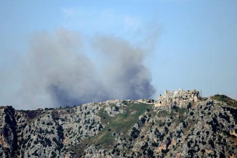 Smoke rises behind the medieval Beaufort Castle.