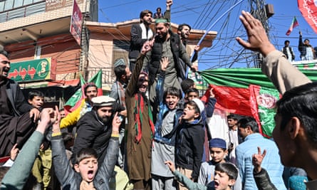 PTI activists gather outside a polling station during Pakistan's national election in Islamabad on 8 February 2024